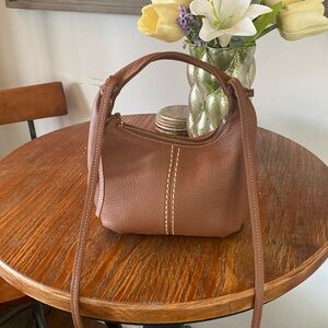Roots Greener Pastures Small Brown Pebbled Leather Crescent Moon Crossbody Bag
